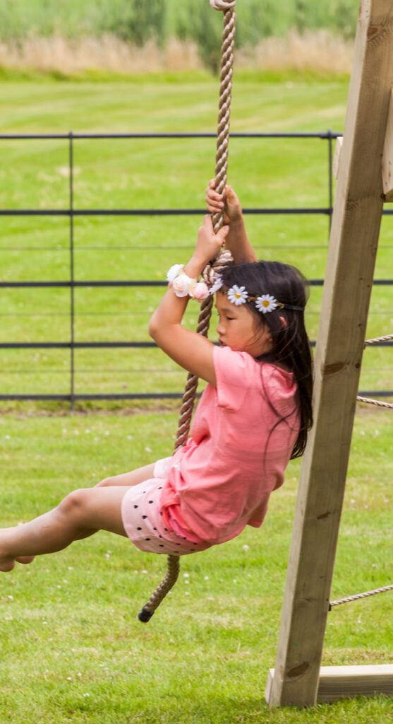 children climbing rope at a school playground equipment in canada